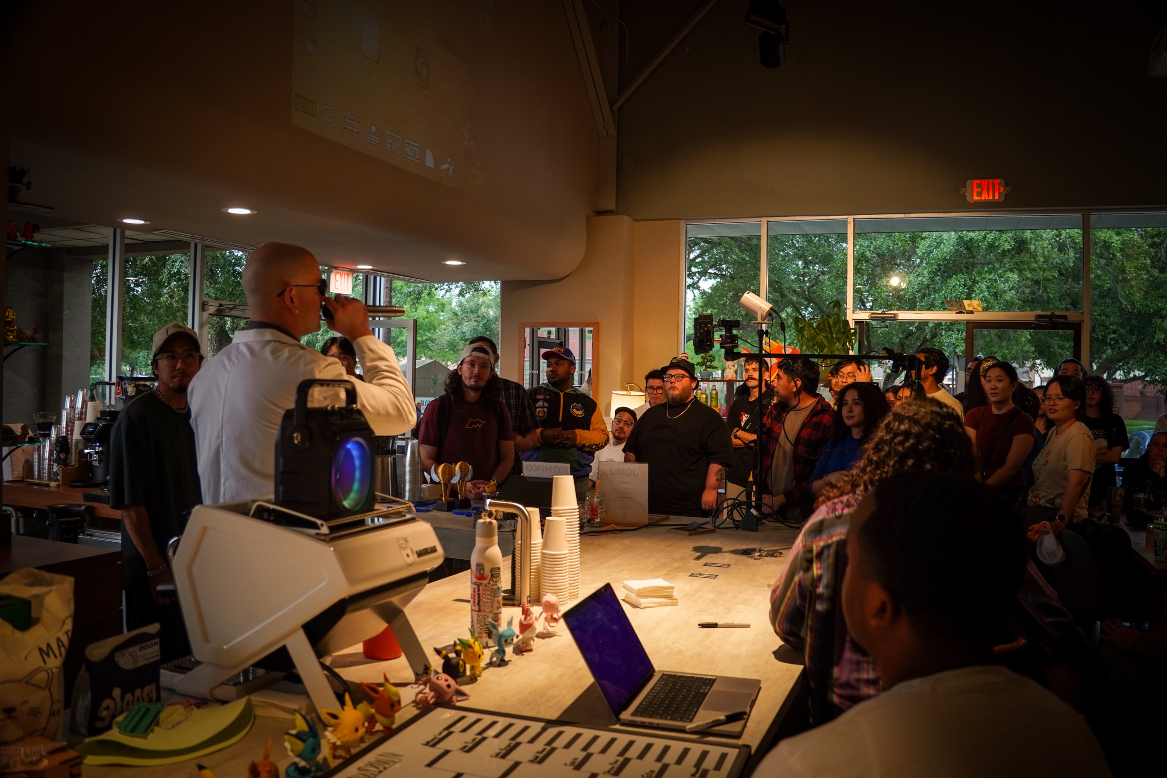 A crowd gathered around a coffee bar during Robert Nguyen's community event